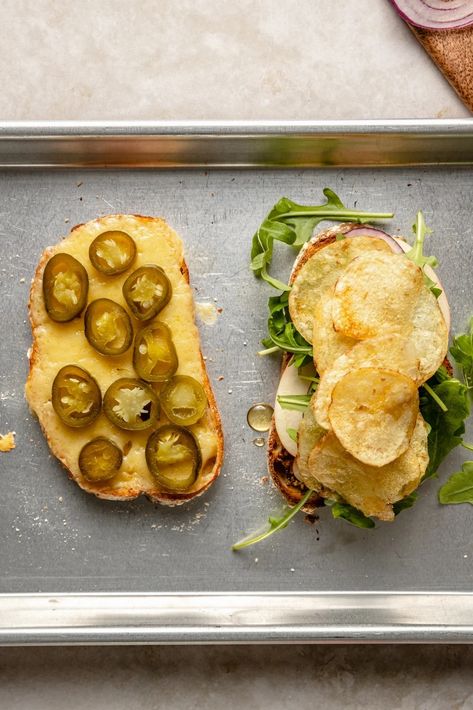 The ULTIMATE spicy cheddar apple sandwich filled with bright veggies and a hint of crunch from kettle potato chips. This wonderful fall veggie sandwich is packed with flavor and a kick of heat from pickled jalapeños. The perfect satisfying lunch to make during the week that's easy to customize with your fav sandwich toppings! #sandwich #healthylunch #vegetarian Fall Sandwiches, Sandwich Toppings, Pickle Sandwich, Yummy Sandwiches, Apple Sandwich, Sourdough Sandwich, Homemade Sandwich, Sandwich Bread Recipes, Ambitious Kitchen