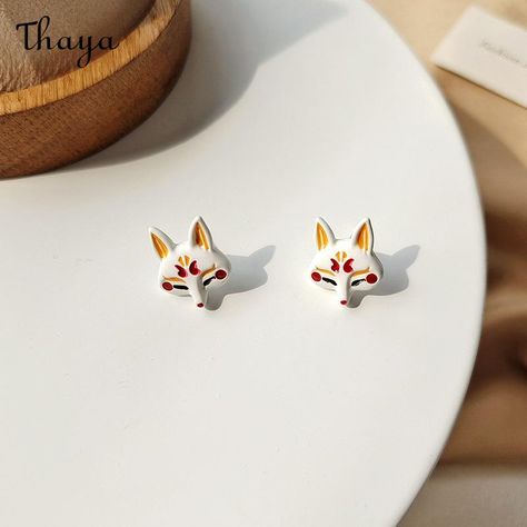 Design concept    The idea behind the fun little fox earrings is to add a playful whimsy to any outfit. The design of these earrings is fun and versatile.    Detail    Brand: Thaya  Material: Alloy + drop oil + paint + oxidation + silver needle  Gender:Female  Style: Animal/Zodiac  Technology: Drip Oil  Mosaic Material: Not inlaid  Size: 1.8*1.4cm  Weight: 1.92g/piece Kitsune Earrings, Sakura Kitsune, Earrings Japanese, Kitsune Mask, Jewelry Traditional, Fox Earrings, Kitsune Fox, Japanese Jewelry, Fox Mask