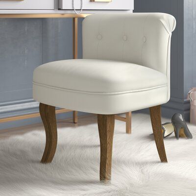 Complete the look in your main bath, dressing room, or at your vanity table with this dainty - and glamorous - stool. Crafted from a blend of solid and engineered wood, the graceful curved legs are finished in a light wood stain and have subtle carved detailing. The plush, foam-filled seat and button-tufted backrest are wrapped in sumptuous, soft-to-the-touch velvet that is available in several eye-catching jewel tones. Given the relatively low seat height (19”), it tucks under most vanity table Light Wood Stain, Accent Stool, Vanity Stool, Wood Vanity, Dressing Table With Stool, Vanity Table, Patio Furniture For Sale, Wood Accents, Bar Furniture