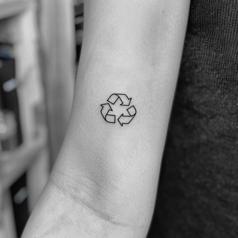 Embrace sustainability with a minimalist tattoo that makes a bold statement. This striking black ink symbol on the forearm, representing recycling, invites us all to commit to a greener planet. Let this be a reminder that every small action counts. Save for eco-inspiration and follow for more ways to live sustainably. #EcoTattoo #Sustainability #RecycleSymbol #MinimalistInk #GreenLiving #SaveThePlanet #EcoFriendly #AIimage Climate Tattoo, Environmentalist Tattoo, Sustainable Tattoo, Environment Tattoo, Earth Tattoo, Live Sustainably, Recycle Logo, Tattoo Concepts, Tattoo On Forearm