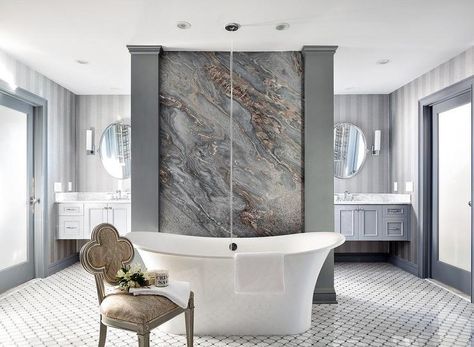 This contemporary bathroom has it all! Stunning gold and black slab marble wall behind a freestanding bathtub next to a Suzanne Kasler Alexandra Chair with decor on top. Vegas House, Forest Creek, Suzanne Kasler, Marble Frame, Best Bathroom Designs, Freestanding Bathtub, Bathroom Design Luxury, Marble Wall, Free Standing Bath