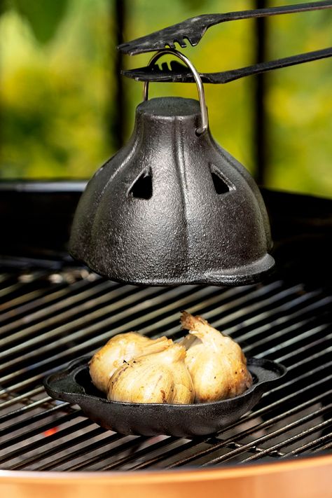 Roast bulbs of garlic on the grill or in the oven inside this Cast Iron Garlic Roaster to tame its harsh bite for a more sweet, savory, and spreadable flavor. Garlic Roaster, Roasted Garlic Cloves, Stocking Stuffers For Men, Uncommon Goods, Quick Weeknight Meals, Unique Kitchen, Foodie Gifts, Roasted Garlic, Food Obsession