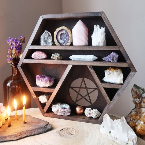 ★ Pentagram Crystal Shelf ★ An original wooden design handcrafted by Kate and her small team at Coppermoon to bring a bit more magic and sacredness into your home. Dimensions Approx: Height 33 cm , Width 33 cm, Depth 4.5 cm This unique hexagon crystal shelf is built perfectly for displaying your crystals and keepsakes. It is made from solid pine and stained in a dark Oak colour. The shelf can either be hung using the attachments that come with it or can be placed on top of other pieces of furnit Crystal Room Decor, Crystal Shelf, Essential Oil Shelf, Pentagram Design, Geometric Shelves, Crystal Room, Crystal Altar, Hexagon Shelves, Crystal Shelves