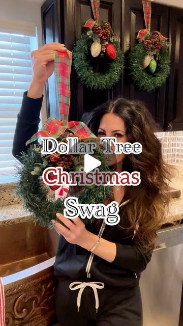 Bethany Mortellaro on Instagram: "🎄 Dollar Tree Christmas Swag

Christmas is finally here! Well, in this house 🤣🙌. These came out beautiful, and I love how they dress up the kitchen. They're also great for windows, staircases, or chair swag. This is a super inexpensive DIY to add some Christmas cheer to the home. 

Items needed from DT:
-foam floral wreath
-garland
-ribbon
-chritmas stems

Wrap the foam wreath with one garland and secure the ends with hot glue. Cut floral stems and pop them into the floral foam. Hot glue ribbon to the back of the wreath. Secure it to the cabinet using painter's tape. Enjoy!

#bethanyscasa #dollartree #dollartreechristmas #christmaswreaths #christmasdiy #christmasaesthetic #dollartreehomedecor @dollartree" Christmas Chair Wreaths, Diy Window Swag Christmas, Garland On Kitchen Cabinets, Ribbon Cabinet Christmas, Diy Christmas Swags, Diy Christmas Swag How To Make, Christmas Swags Ideas Diy, Christmas Cabinets Decorating Ideas, Kitchen Cabinet Christmas Decor