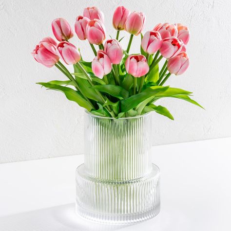 PRICES MAY VARY. HIGH QUALITY: Our quarter inch thick, waterproof, clear vases are custom designed to ensure they are durable and flawless. The base is half an inch thick. We’ve also hand selected and customized quality tulip stems so that they are sturdy and long lasting. ULTRA REALISTIC: Although It is impossible to beat nature, we nonetheless put in utmost efforts to produce the most realistic looking tulips available, in both style and color to match authentic freshly picked tulips. The colo Faux Tulips, Ribbed Glass Vase, French Style Decor, Tulips Arrangement, Artificial Tulips, Fluted Vase, Clear Glass Vase, Clear Vases, Clear Vase