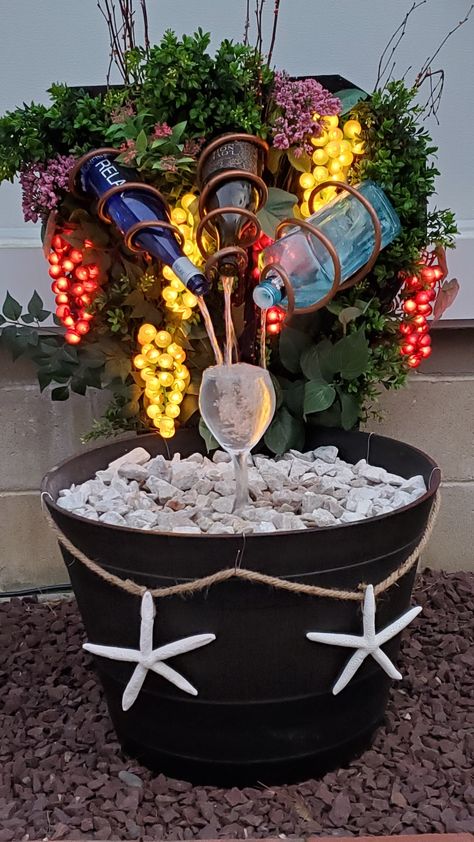 Lighted wine bottle fountain Wine Fountain, Wine Bottle Water Feature, Wine Bottle Water Fountain, Wine Bottle Solar Lights Outdoor, Solar Lighted Wine Bottle Tree, Wine Bottle Fountain, Rock Bubbler Fountain, Lighted Wine Bottles, Backyard Deck