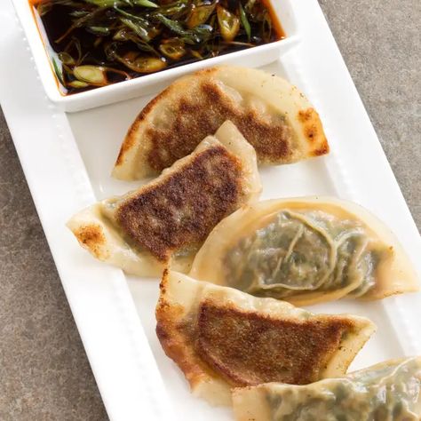 Cabbage and Mushroom Potstickers | America's Test Kitchen Recipe Cabbage And Mushrooms, Veggie Potstickers, Gyoza Wrappers, Scallion Sauce, Donut Toppings, Cookie Toppings, Caramel Tart, Pot Stickers, Vegetarian Cookbook