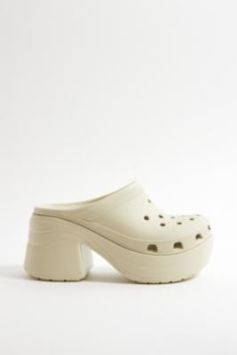 Your favorite Crocs now with a chunky heel. The Crocs Siren features added height while the iconic Crocs Comfort keeps them lightweight, flexible, breathable and buoyant thanks to Iconic Crocs Comfort foam. **Content + Care** \- Rubber \- Wipe clean | Crocs Bone Siren Heeled Clogs - Cream UK 5 / EU 37-38 at Urban Outfitters Siren Features, Crocs Heels, Clean Crocs, Shoes List, Clog Outfit, Heeled Clogs, Croc Heels, Clog Heels, Chunky Heel