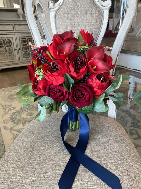 "Stunning dark red bridal bouquet! This bouquet is made with high quality silk flowers consisting of peonies, calla lilies, roses, tulips and eucalyptus leaves. It has all the elegance, beauty and romance you could want and the wow factor you are looking for. Each floral arrangement is handmade with great attention to detail and fine craftsmanship. Bouquets are finished with ribbon color of your choice. You can be sure to love the product you receive and it will last and be beautiful for years to come!  *Pictures show 13-14\" bride bouquet*-  This bouquet can be customized to your liking and needs. If you would like a different color palette, different  accent or different type of flowers I am very accommodating. I love to work with brides to make you exactly what you are hoping for on you Red Flower Bouquet For Prom, Red Prom Flowers Bouquet, Bridal Bouquets Winter, Navy Bouquet Wedding, Red Prom Bouquet, Tulips And Eucalyptus, Prom Flowers Bouquet, Navy Bouquet, Red Flower Bouquet