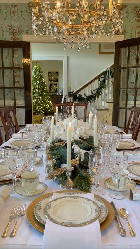 41K views · 5.1K reactions | Will you be hosting or guesting this holiday season? As I continue to deck the halls, I’m taking a walk down memory lane, looking back at one my favorite Christmas tables. The centerpiece was a base of two faux cypress swags. I used mostly things that I already had including my wedding china on top of gold chargers, white linens, crystal glasses, silver candle holders with faux ivory taper candles and mercury glass votives. I embellished with gold and white poinsettia flowers, white birds, deer, faux antlers, gold peacocks, and neutral nutcrackers. Last, I added Christmas crackers at each place setting for a touch of fun. I hope this tablescape inspires you to create your own beautiful table for the holidays. I’ve seen all of these same items this year when I Christmas White And Gold Table Setting, White Poinsettia Wedding, Christmas Dining Table Metal Chargers White Plates, Gold Charger Plates Table Setting Christmas, Tablescapes With Spode Christmas Tree, Whiye Ivory And Gold Christmas Table, Faux Antlers, Poinsettia Centerpiece, White Poinsettia