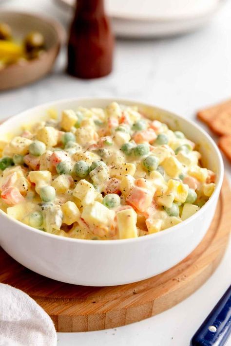 Olivier Salad is a vegetarian salad recipe for a Russian classic made of potato, mayo, eggs, peas, and carrots. A simple and quick recipe for a divine dish. This Russian classic goes from pantry to table in 30 minutes and it's great for vegetarian and gluten-free diet. #jernejkitchen #russiansalad #saladrecipes #oliviersalad Salad Names, Olivier Salad, Vegetarian Salad, Peas And Carrots, Vegetarian Salad Recipes, Vegetarian Salads, Fair Food, Yummy Salad Recipes, 30 Minute Meals