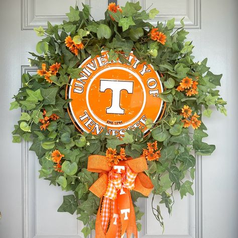 Available with 20% off. https://lauradesignswreaths.com/tn-vols-wreath-with-ivies-and-optional-flowers-or-bows/ #lauradesignswreaths #laura혜영 #rockytoptennessee #rockytop #volsdecor #tnvols #gobigorange #volsdoordecor Ut Wreath, Rocky Top Tennessee, Tn Vols, Rocky Top, Ivy, Wreath, Flowers