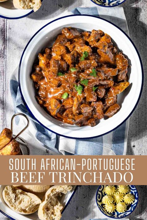 Trinchado in a white bowl with a dish of bread rolls and a small basket of chips. South African Beef Stew, Trinchado Recipe, Beef Trinchado, African Beef Stew, African Stew, South African Dishes, Cubed Steak, The Stew, Portugal Food