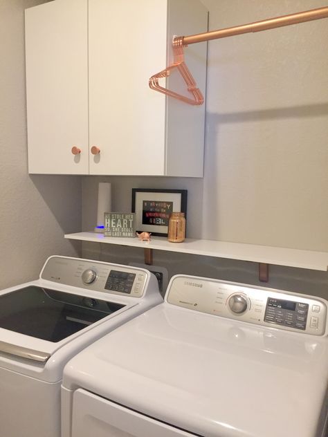 LOVE my Rose Gold/ Cooper laundry room! See the “tried this” section for the “before” picture. Of course the washer and dryer were expensive but everything else was pretty simple! IKEA cabinet, hangers from Amazon, spray paint and a simple closet rod from Home Depot... Plus the tiny elephant ring holder (Wayfair) to keep my ring safe. Rose Gold Laundry Room Ideas, Rose Gold Laundry Room, Gold Laundry Room, Rose Gold Interior Design, Rose Gold Interior, Elephant Ring Holder, Laundry Room Update, Ikea Cabinet, Small Laundry Room Makeover