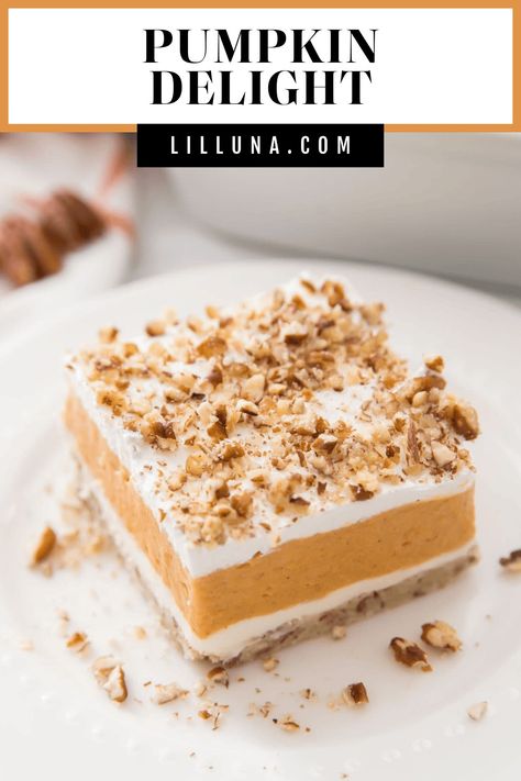 Tasty 4 layer pumpkin delight dessert starts with a crunchy pecan crust topped with creamy pumpkin, cream cheese, and whipped cream layers! #pumpkindelight #pumpkin #pumpkinrecipes #layereddessert #dessert Pumpkin Delight Dessert Recipe, Pumpkin Cream Cheese Bars, Layered Pumpkin Dessert, Delight Dessert, Pumpkin Dump Cake Recipe, Pumpkin Delight, Dump Cake Pumpkin, Lil Luna, Pumpkin Pudding