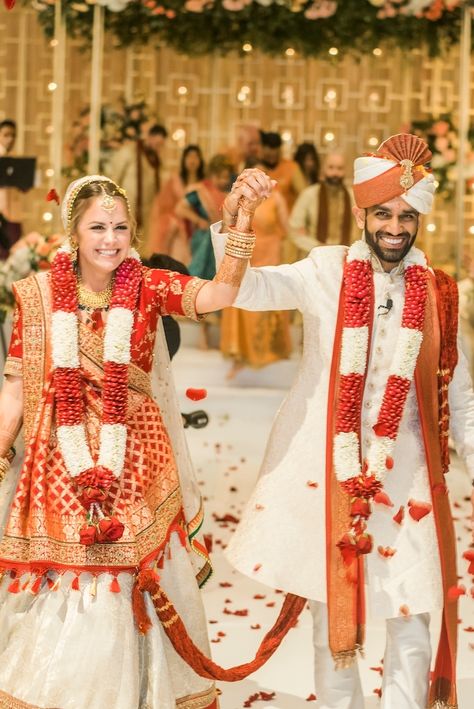 Bride and groom exit their Hindu ceremony after saying "I Do" in colorful and vibrant traditional Indian wedding attire | Photo: Oryan Photo and Video | #weddingsinhouston #realwedding #brideandgroom #indianwedding #hinduceremony #indianweddingdresses #indianweddingoutfits #weddingattire #weddinginspo #weddingideas #bridallooks #bridalstyle Peach And Dusty Blue, Bride And Groom Exit, Indian Wedding Attire, Asian Inspired Wedding, Indian Reception, Hindu Wedding Ceremony, Hindu Ceremony, Indian American, Outfits Wedding