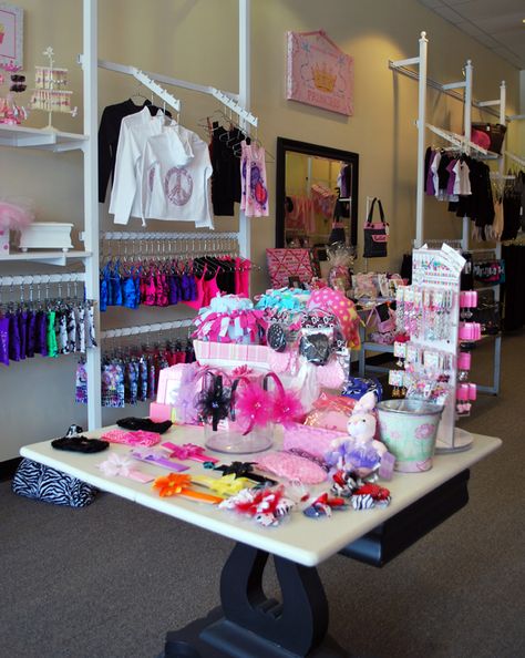 At On Pointe Dancewear N Apparel, a table at the front of the store showcases small gift items, which helps attract passing nondance customers. (Read all about this store in the June issue!) Dance Store Ideas, Gym Lobby, Cheer Gym, Dance Studio Decor, Apparel Business, Dance Store, Floating Table, Ballet Studio, Attract Customers