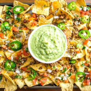 These Spicy Ground Beef Nachos have the potential to save your day. Chipotles in adobo give the beef real kick and when loaded on cheese covered tortilla chips they quickly become a go-to meal. Served with a homemade Avocado Salsa Verde and your choice of fixings. So good! mexicanplease.com Ground Beef Nachos, Nachos Recipe Beef, Mexican Nachos, Beef Nachos, Taquitos Beef, Doritos Nachos, Mexican Appetizers, Hispanic Kitchen, Nachos Beef