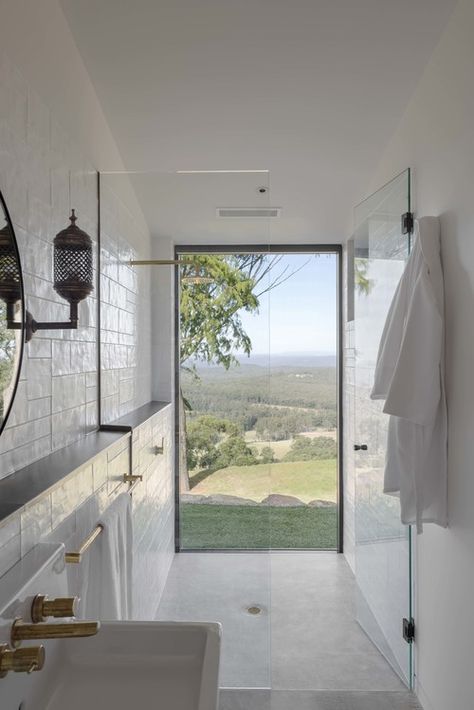 Bathroom: walk-in shower with floor-to-ceiling window with a view, brushed/matt brass taps and towel rail, white handmade wall tiles, robe hook, white concrete floor Smallest Bathroom, Valentine Home Decor, Window In Shower, Australian Interior Design, Master Ensuite, Interior Design Awards, Diy Valentine, Energy Boost, Small Bathroom Design