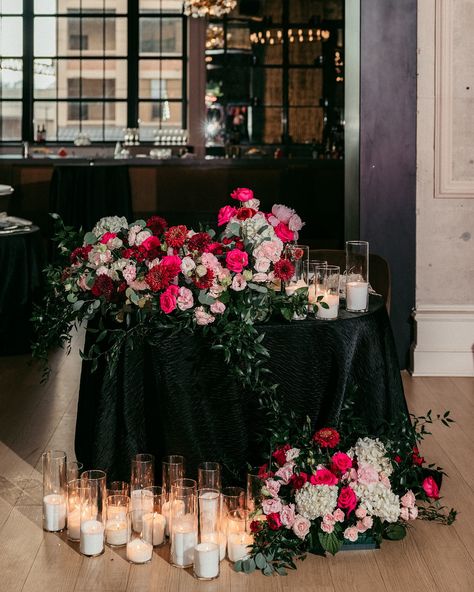 All eyes on the newlyweds and the sweetheart table that is decorated to their liking! 🩷 This HOT pink wedding was the hot topic among guests, wedding teams, and everyone who was WOW-ed by these beautiful pictures captured by @lovestruckpictures photographers! The centerpieces for this gorgeous sweetheart table at @cescaphe ‘s Swith House had a white base with many hot pink elements and touches of red. Sitting atop black tablecloths and situated beside the gentle glow of our candles, we were ... Black Tie Wedding With Color, White And Black Sweetheart Table, Black Wedding Sweetheart Table, Black And White Sweetheart Table, Hot Pink Wedding Theme, Dark Pink Wedding, Black Tablecloths, Pink Elements, Hot Pink Wedding