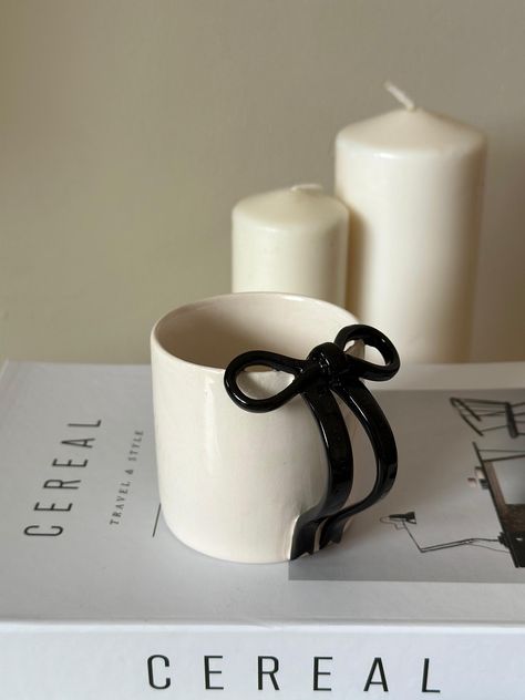 Introducing the Unique Handmade Ceramic Black Ribbon Mug, a truly one-of-a-kind piece of art that elevates your coffee experience. Each mug is meticulously crafted by skilled artisans, ensuring that no two pieces are exactly alike. Discover the blend of beauty and functionality in this stunning ceramic creation: 🔹 Exclusive Design: This mug boasts a striking black ribbon design, adding a touch of elegance to your morning routine. Its unique pattern is hand-glazed, ensuring every sip is as styli Handless Mug, Fast Ceramic Projects, Minimalist Ceramic Mug, Music Ceramic Art, Ceramic Mug Handles Ideas, Big Mugs Ceramic, Homemade Ceramic Mugs, Ceramic Mug Diy, Girly Ceramics