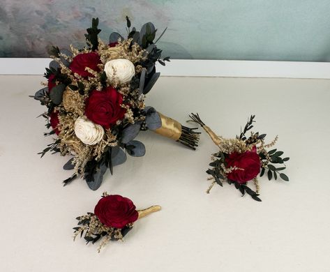 Winter wedding arrangements made of sola flowers, dried flowers, and preserved eucalyptus. Soft wooden flowers in deep red, gold and ivory, with gold painted dried flowers and preserved eucalyptus greenery. Stems with satin ribbon. Smells wonderful!  Will serve you on your Big Day and a long time after.  MADE ON ORDER Dimensions:  BRIDAL BOUQUET                            height approx. 28 cm(11 1⁄32"),                             diameter approx. 25cm(10") MEDIUM BOUQUET Gold And Red Bouquet, Red And Gold Flower Centerpieces, Red And Gold Bridal Bouquet, Dark Red Bouquet, Wedding Burgundy And Gold, Winter Wedding Gold, Wedding Bouquets Red, Medium Bouquet, Ivory Bouquet