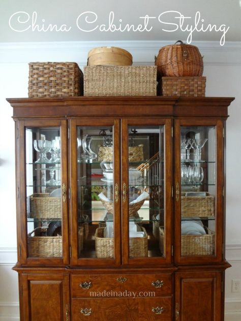 Could your China cabinet use a makeover? Get more useful storage out of your furniture. Baskets On Top Of Hutch, Decorate Top Of China Cabinet, Decorating Top Of Hutch, Top Of Hutch Decor, China Cabinet Styling, Traditional China Cabinet, Cabinet With Baskets, Armoire Decor, China Cabinet Decor