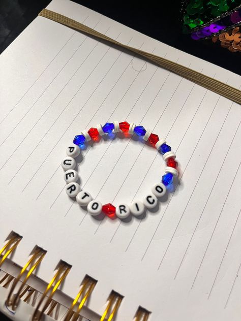 handmade puerto rico beaded bracelet 🇵🇷. made with 4mm and 6mm bicone crystal gems and white letters on elastic string. message with any comments,questions, or concerns 🤍. Puerto Rico Diy Crafts, Puerto Rico Bracelet, Beaded Braclets, Crystal Bead Jewelry, Bracelets Patterns, Bracelets Design, Porto Rico, Diy Bracelet Designs, Diy Bracelets Patterns