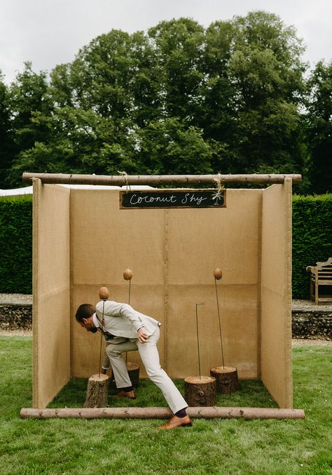 This shows our coconut shy game outdoors. There are wooden blocks with metal stands displaying coconuts. Above the stands are a sign that reads "coconut shy" Coconut Shy, Garden Games, Modern Games, Game Collection, Carnival Games, Photography Games, Knock Knock, Carnival, Coconut