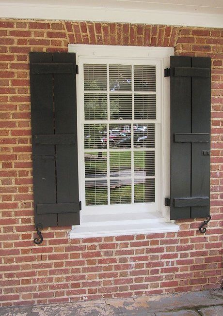 real-board-and-batten-shutters Brick Curb Appeal, Exterior Shutters On Brick, Black Shutters, House Shutters, Board And Batten Shutters, Diy Shutters, Retro Renovation, Red Brick House, Shutters Exterior