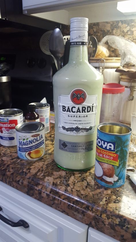 Coquito  Recipe: 2 cans evaporate milk, 2 cans cream of coconut, 1 can of condensed milk, 400 ml of white rum, 1 teaspoon vanilla extract, 1 teaspoon cinnamon.  Mix all ingredients with a whisk then transfer it to a bottle (I used the one that had the rum ). Chill in refrigerator.  Shake before you serve. Enjoy. How To Make Coquito, Infused Spirits, Jello Pudding Shots, Coquito Recipe, Best Mixed Drinks, Latino Food, Cream Of Coconut, Weekend Food, Party Drinks Alcohol