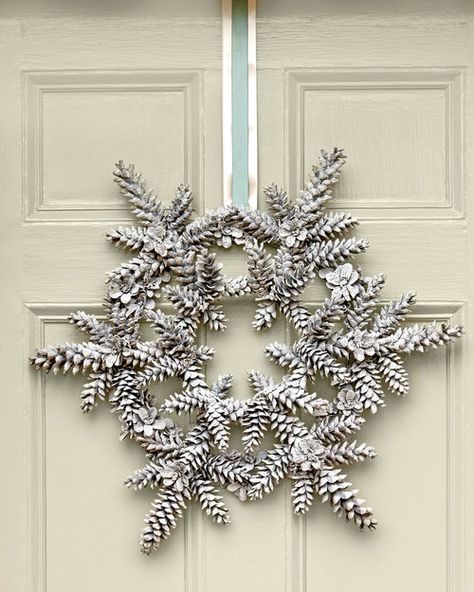 This winter white wreath is the perfect decoration to greet guests with a warm, holiday welcome. Snowy Pinecone, Dekoratívne Vence, Pinecone Crafts, Pine Cone Art, Cone Crafts, Snowflake Wreath, Pine Cone Decorations, Cones Crafts, Pine Cone Crafts