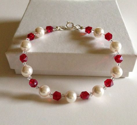 "Pearl bracelet, This is a beautiful swarovski pearl and crystal beaded bracelet the pearls are 8mm in size and are white in color, the crystals are a ruby red with a tiny clear crystal on either side of each ruby red crystal, this one has the sparkle factor without being overwhelming. the bracelet will fit up to a 7 and 1/4\" wrist. The bracelet is finished with sterling silver clasp, guardians and silver beads. Images may appear larger than actual size to show detail." White And Red Bracelets, Red Pearl Bracelet, Red Beads Bracelet, Pearl Bracelet Aesthetic, Collares Aesthetic, Red Bead Bracelet, Red Beaded Bracelet, Red Bracelet, Diy Jewelry Unique