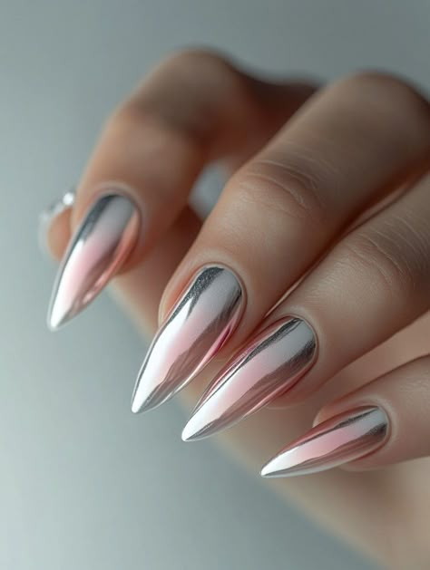 Combine futuristic shine with a classic gradient in this stunning chrome ombre nail design. Featuring a sleek metallic finish that transitions from silver to pastel pink, this look is perfect for any occasion where you want to stand out.    **Steps to Create the Look:**   1. Apply a clear or nude base coat for a smooth foundation.   2. Use a chrome powder to create a metallic effect, starting at the base and fading toward the tips.   3. Blend the chrome into pastel pink polish for a seamless ombre transition.   4. Seal the design with a glossy topcoat to enhance the metallic shine.    **Tagged Topics:**   #ChromeOmbreNails, #MetallicManicure, #FuturisticNailArt, #ElegantGradient Nail Color Combinations Ideas, Ombre Metallic Nails, Ombre Chrome Nails Almond, French Ombre Chrome Nails, Chrome Tipped Nails, Chrome Ombre Nails Designs, Mirrored Nails, Metallic Ombre Nails, Chrome Ombré Nails