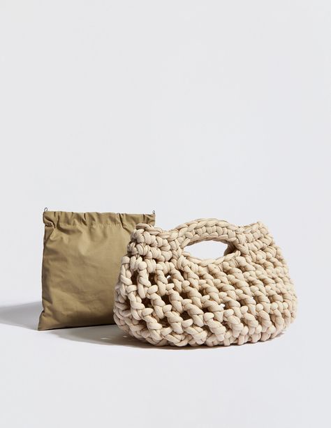 In a chunky, texture-rich design, this handmade clutch is structured in an exaggerated braided crochet with a detachable waterproof pouch for your wallet, phone and keys. In a rounded, open-top silhouette and crocheted in a cotton + hollow fibre yarn, this hand-crafted handbag elevates any look with a bespoke finish. 100% eco yarn Detachable waterproof pouch Height: 11” x Width: 12” Pouch: Height: 8.5” x Width: 7.5” Handmade in Greece Crochet Bag Outfit, Crochet Macrame Bag, Chunky Yarn Bag, Pouch Bag Crochet, Handmade Bags Crochet, Hand Crochet Bag, Chunky Crochet Bag, Crochet Round Bag, Clutch Bag Tutorial