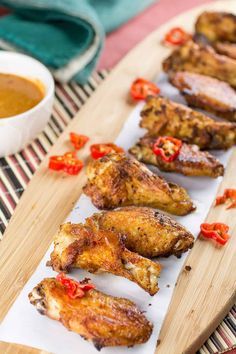 These chicken wings are rubbed with ghost pepper spice then baked to crispy perfection, served with a buffalo-blue cheese sauce and crumbled blue cheese. Here is the recipe. Time for something extra spicy today, friends and chili pepper lovers. We're talking ghost pepper hot. Do you have a favorite buffalo wing joint? Most people do. I have a few different favorites, depending on my mood, though each one is different. Some focus on the rubs, some focus on the sauce, though the one thing almost a Wings Sauces, Wing Sauces, Pepper Chicken Wings, Bbq Meats, Best Chicken Wing Recipe, Hot Wing Recipe, Wings Recipes, Chili Pepper Recipes, Wing Sauce Recipes