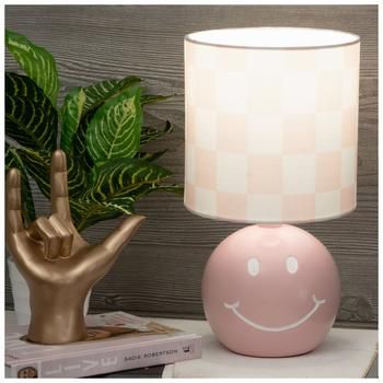 Base Dimensions: 5.75" W x 5.75" D Shade Dimensions: 7" H x 7" W x 7" D Full Height: 13" Cord Length: 62" Bulb Type: Bulb Type: A 60W Power Source: Corded Electric Material: Resin, Metal & Fabric Color: Pink & White Pattern: Check Quantity: 1 Brighten up your kiddo's room with groovy accents such as this Smiley Face Checkerboard Lamp. The base of this lamp is round and features a pink pastel color with a smiley face engraved onto the front. Finishing off the look of this lamp is a drum shade that boasts a pink and white checkerboard pattern. Pair it with a cute lava lamp and flower string lights for a cute and cohesive display!   *No discounts may be applied to "your price" or "reduced" items. Pink Checkered Nursery, Pink And Yellow Room Decor, Smiley Face Room Decor, Preppy Lights, Preppy Lamp, Checkered Lamp, Cute Things For Your Room, Cute Decorations For Bedrooms, Cute Room Pink