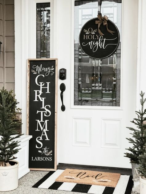 A Simple & Rustic Farmhouse Christmas Front Porch - Cream and Black Winter decor, faux green Christmas trees, farmhouse wood signs, and simple garland - Rain and Pine Outdoor Winter Signs Front Porches, Wooden Christmas Porch Decor, Xmas Wood Signs, Farmhouse Christmas Signs Wooden, Outdoor Christmas Signs Front Porches, Christmas Wooden Wreaths, Front Porch Christmas Signs Wooden, Christmas Wood Signs Porches, Front Porch Christmas Sign