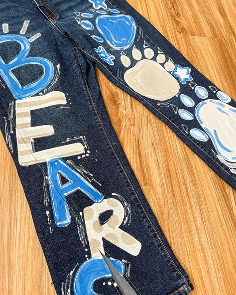 Looking for painted jeans? I am now doing customizable jeans!🩵🫶🏼🤪 #jeans #paintedjeans #art #paint #seniorjeans #smallbusiness Hoco Jeans Painted, Jean Painting Ideas, Homecoming Jeans, Jean Painting, Senior Jeans, Painted Jeans, Painted Clothes, August 17, School Spirit