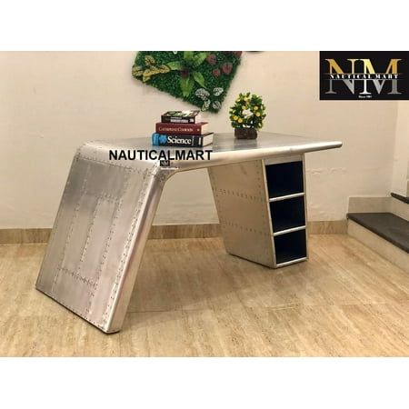 Style: Exclusive NM Aviator Wing Desk Industrial Style. Material: Beautiful Handcrafted (Aluminum and Recycled Wood). Specific Use: Home/Hotel/Restaurant/Salon/Club/Office/Bar etc. Excellent Quality Inspired by World Warr Aircraft. Packing Material: PE Foam, Polystyrene Foam, Nine layers corrugated paper carton with corner proof, Plywood Frame. This Desk is riveting, soaring with the flair of an airplane wing and guaranteed to help a room take flight. Crafted from polished aluminum and rivets, t Desk Industrial Style, Airplane Wing, Desk Industrial, Industrial Style Desk, Aviation Decor, Wood Computer Desk, Club Office, Plywood Frame, Industrial Desk