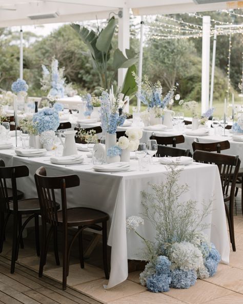 Long Table Centerpieces Wedding Hydrangeas, Sky Blue Table Setting, Delphinium Centerpiece Wedding, Baby Blue Wedding Table Decor, Blue Hydrangea Centerpieces Wedding, Beachy Floral Arrangements, Blue Garden Party Wedding, Light Blue Wedding Table Decor, Blue Hydrangea Wedding Centerpieces