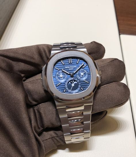 The new PATEK PHILIPPE NAUTILUS ref. 5740/1G: A true “halo timepiece” - Perpetual calendar in an elegant white gold case with a stunning blue sunburst dial. Impressive and beautiful! #kirkjewelers #baselworld #patekphilippe #OfficialRolexJeweler #tudorwatch Patek Philippe Blue, Patek Philippe Perpetual Calendar, Patek Phillipe, Patek Philippe Watches Men, Money Clothes, Stylish Watches Men, Gentleman Aesthetic, Patek Philippe Watches, Fancy Watches