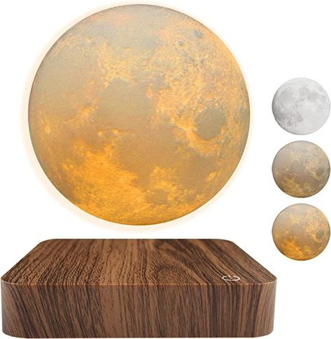 Illuminate your office space in a way that's out of this world with our Levitating Moon Lamp. This magnetic floating masterpiece offers a unique, eye-catching design and three stunning color modes to set the perfect ambiance. Experience the mesmerizing spin and enchanting glow that will elevate your home décor to new heights. Don't miss out on this captivating conversation starter – Follow us for more! Levitating Moon Lamp, Moon Light Lamp, Moon Night Light, Holiday Room Decor, Tech Gadgets Gifts, Bedroom Unique, Desk Lamps Bedroom, Lamp 3d, Holiday Room