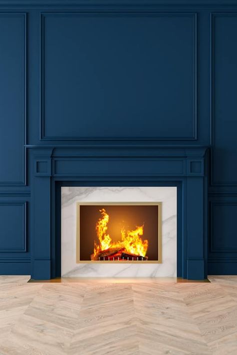 Give your fireplace the dramatic backdrop it deserves with an accent wall that stands out. This article will reveal nine eye-catching colors that are perfect for adding an extra touch of elegance and excitement to your room. Royal Blue Fireplace, Box Molding Fireplace, Wainscoting Ideas Around Fireplace, Chimney Accent Wall, Fireplace And Wall Same Color, Batten Board Fireplace Wall, Slatwall Fireplace, Blue Accent Wall Living Room Fireplace, Navy Blue Fireplace Wall