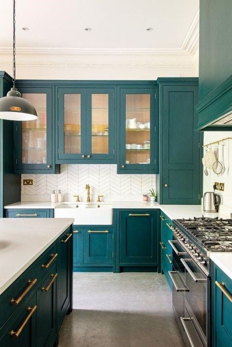 a teal kitchen with glass and usual cabinets, white countertops and a white tile backsplash, gold fixtures and handles Teal Kitchen Cabinets, Teal Cabinets, Cheap Backsplash, Kitchen Decor Trends, Herringbone Kitchen, White Tile Backsplash, Teal Kitchen, Bespoke Kitchen, Dirt Cheap