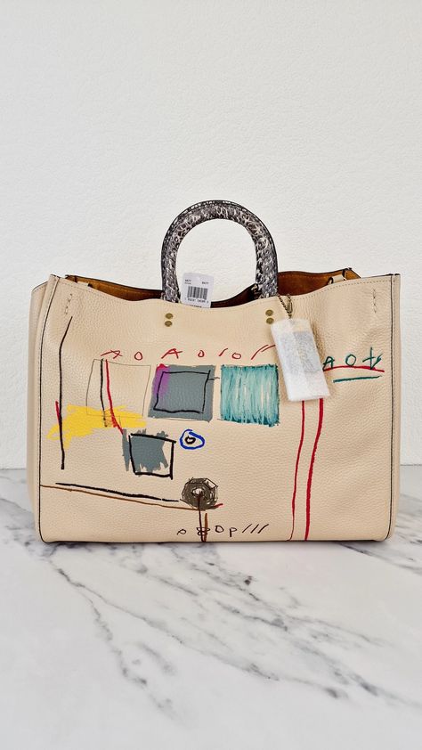 Coach Rogue 39 Jean-Michel Basquiat Bag in Ivory Pebble Leather with S – Arid Bag Coach Rogue, Snake Skin Handbag, Coach 1941, Jean Michel Basquiat, Jean Michel, Bottega Veneta Shoulder Bag, Colorful Artwork, Wallet Case, Pebbled Leather