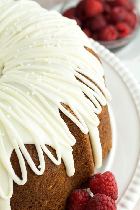 This Ultimate White Chocolate Raspberry Bundt Cake is a made-from-scratch nod to the Nothing Bundt Cakes’ famous flavor combination. It is a decadent white chocolate batter swirled with homemade raspberry sauce and topped with a white chocolate ganache frosting. Included are all the tips and tricks to make sure your cake comes out beautiful and stays ultra moist. #whitechocolate #raspberry #cake #bundtcake #fromscratch #homemade White Chocolate Raspberry Bundt Cake, Chocolate Raspberry Bundt Cake, White Chocolate Ganache Frosting, Raspberry Bundt Cake, White Chocolate Raspberry Cake, White Chocolate Frosting, Chocolate Ganache Frosting, Nothing Bundt, Nothing Bundt Cakes