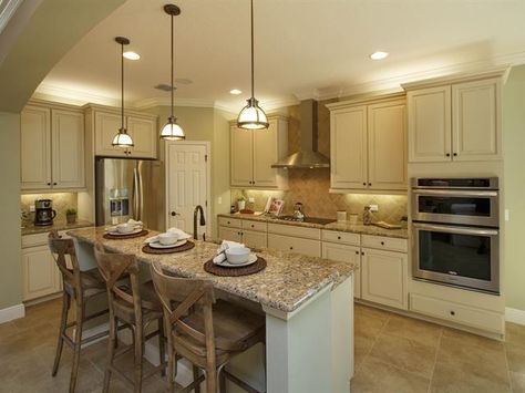 This elegant kitchen has a soft color scheme. The sandy colors in the cabinets and the dim low hanging lights create a comfortable and warm space. Kitchen No Windows, Kitchen Without Window, Kitchens Without Windows, Kitchen No Window, Windowless Kitchen, Church Renovation Ideas, Ranch House Renovation, Cream Travertine, Small Basement Kitchen