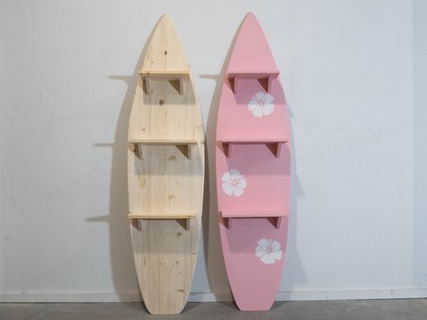 Wooden Surfboard with 3 attached shelves in baby pink color with hibiscus flowers.  Dive into coastal charm with our Wooden Decorative Surfboard featuring functional flair. Available in both clear, unpainted simplicity and a delightful baby pink hue adorned with three charming hibiscus flowers, this surf-inspired shelf unit adds a touch of beachside elegance to any space. Crafted from high-quality FSC Pine wood, the clear version serves as a versatile blank canvas for your creativity or a minima Surf Board Shelf, Hawaiian Theme Room, Hibiscus Flower Decor, Simple Beach Room Decor, Surfboard Bookshelf, Beach Room Asthetics, Cute Surfboard Designs, Hibiscus Room Decor, Pink Coastal Room