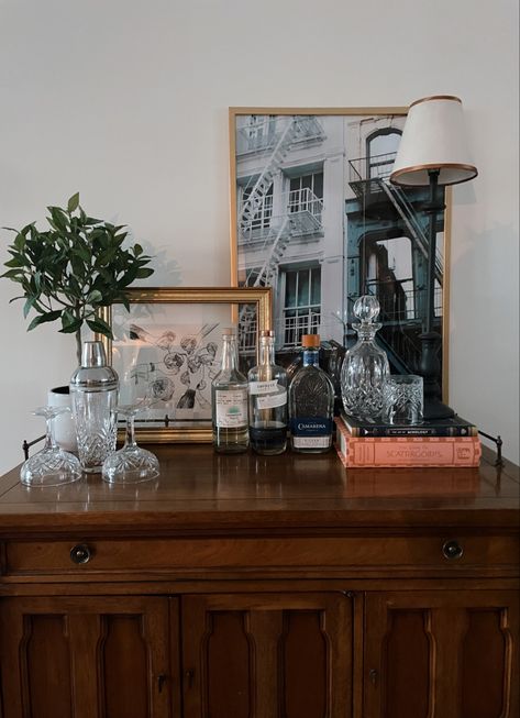 #inspo #barcabinetstyling #vintage #barcartdecor #style #homedecoration #homestyledecor Vintage Bar Cabinet Styling, Mirror Above Bar Cart, Vintage Coffee Table Styling, Bar Credenza Styling, Bar Buffet Cabinet Decor, Bar Table Styling, Styling A Bar Cabinet, Vintage Bar Decor Ideas, Dark Brown Apartment Aesthetic